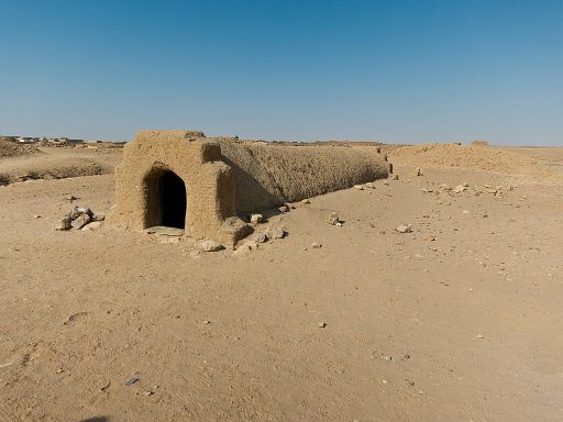 Exterior of one of the ancient Nubian  tombs at El-Kurru near Karima, Sudan.  A stariwell angles down into the sand to a tomb with two small rooms.  The tombs here date from circa 1000 BCE.  Most of the pyramids and tombs have been destroyed, but you can still visit the tombs of Pharoah Tanutamen and his mother, Qalhata.